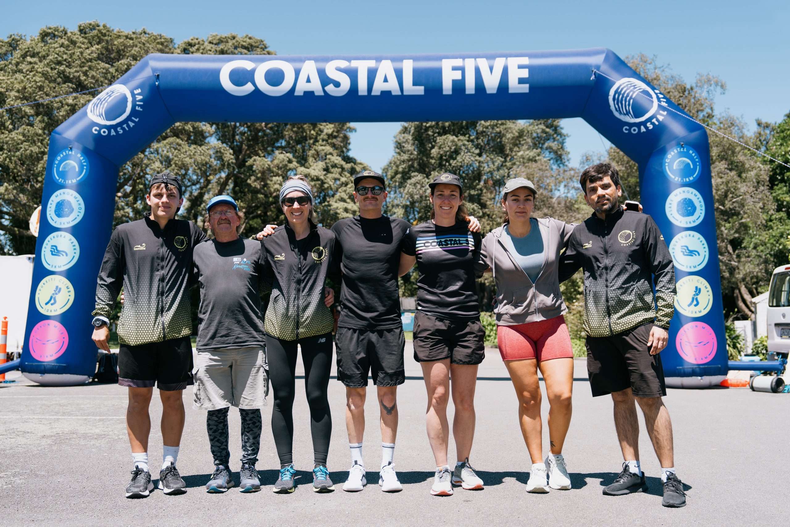 The Coastal Five Event Crew – Making Magic Happen Coastal Five event crew smiling and celebrating at the finish line in New Plymouth.